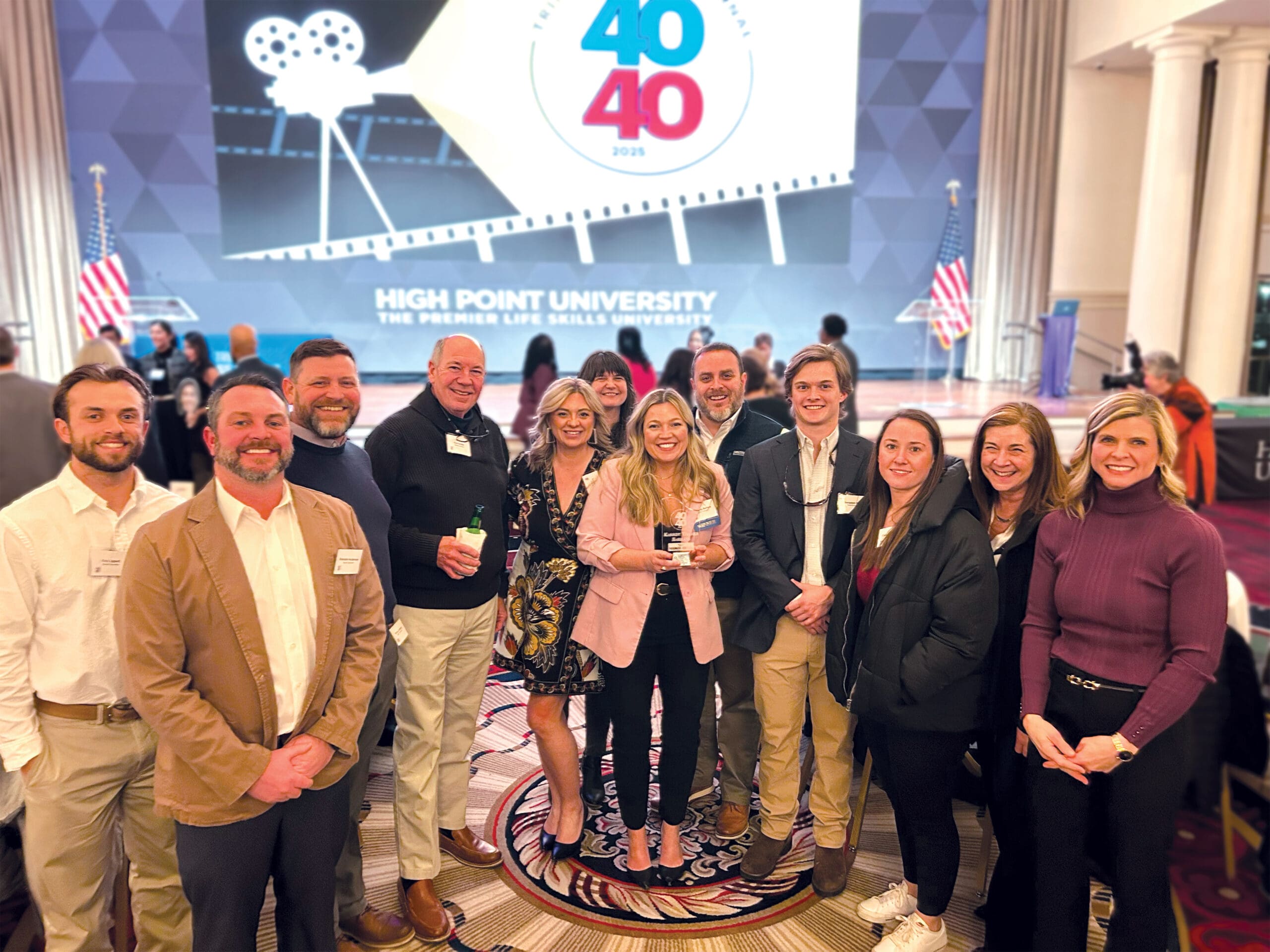 Samet Corporation team member Kassidy being recognized at the 40 Under 40 awards, highlighting achievements in the construction industry