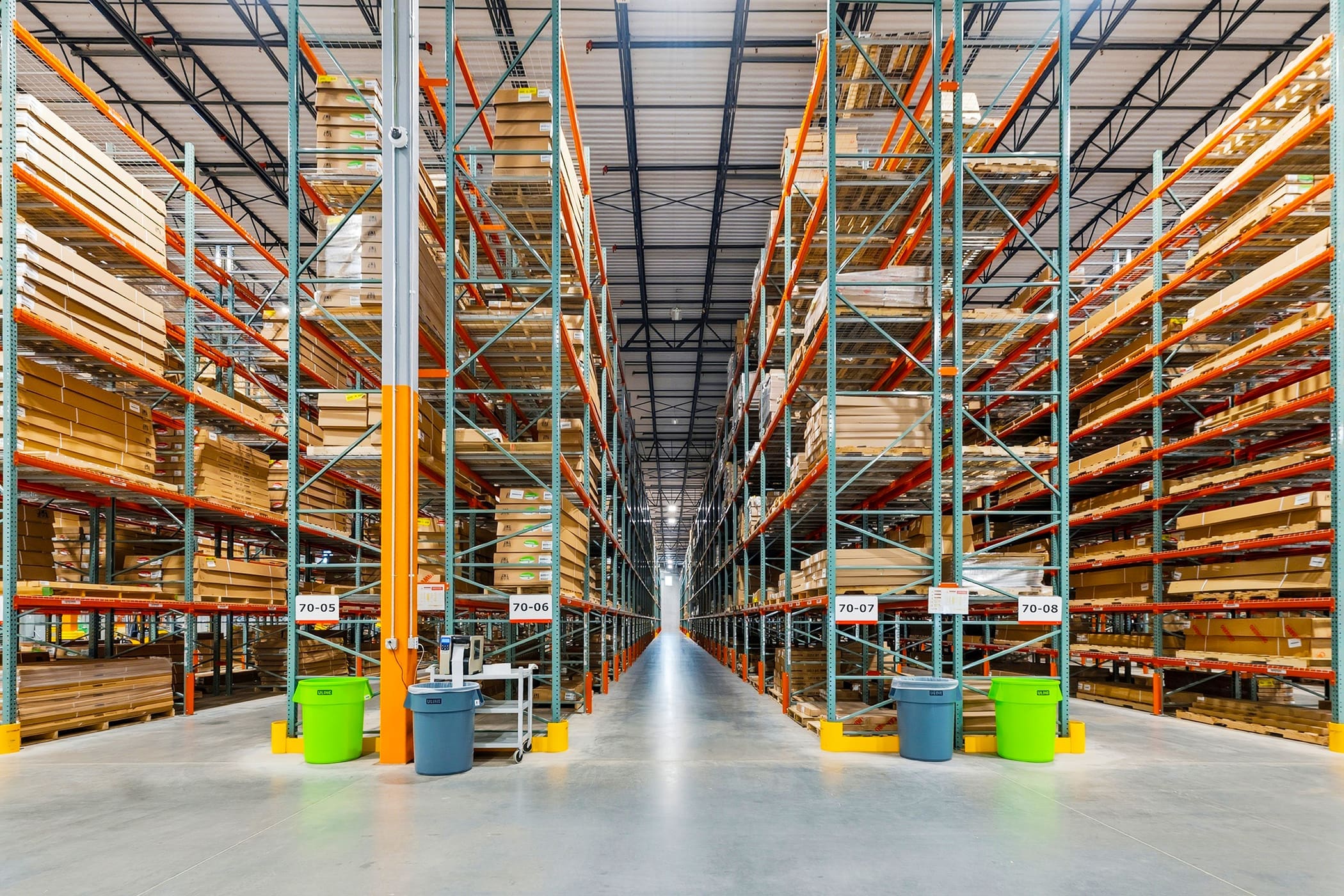 Warehouse aisle with tall pallet racks and inventory storage
