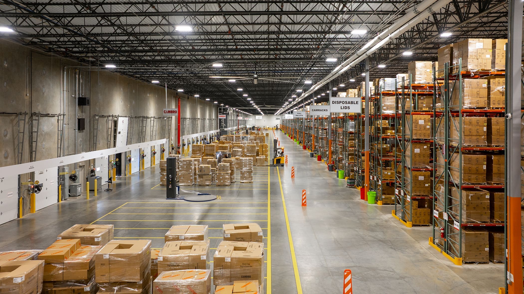 Large industrial warehouse interior with shelving and pallet storage