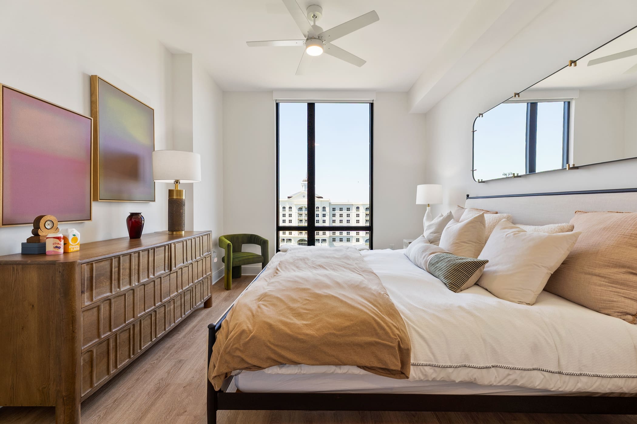 Contemporary apartment bedroom with large windows and natural light