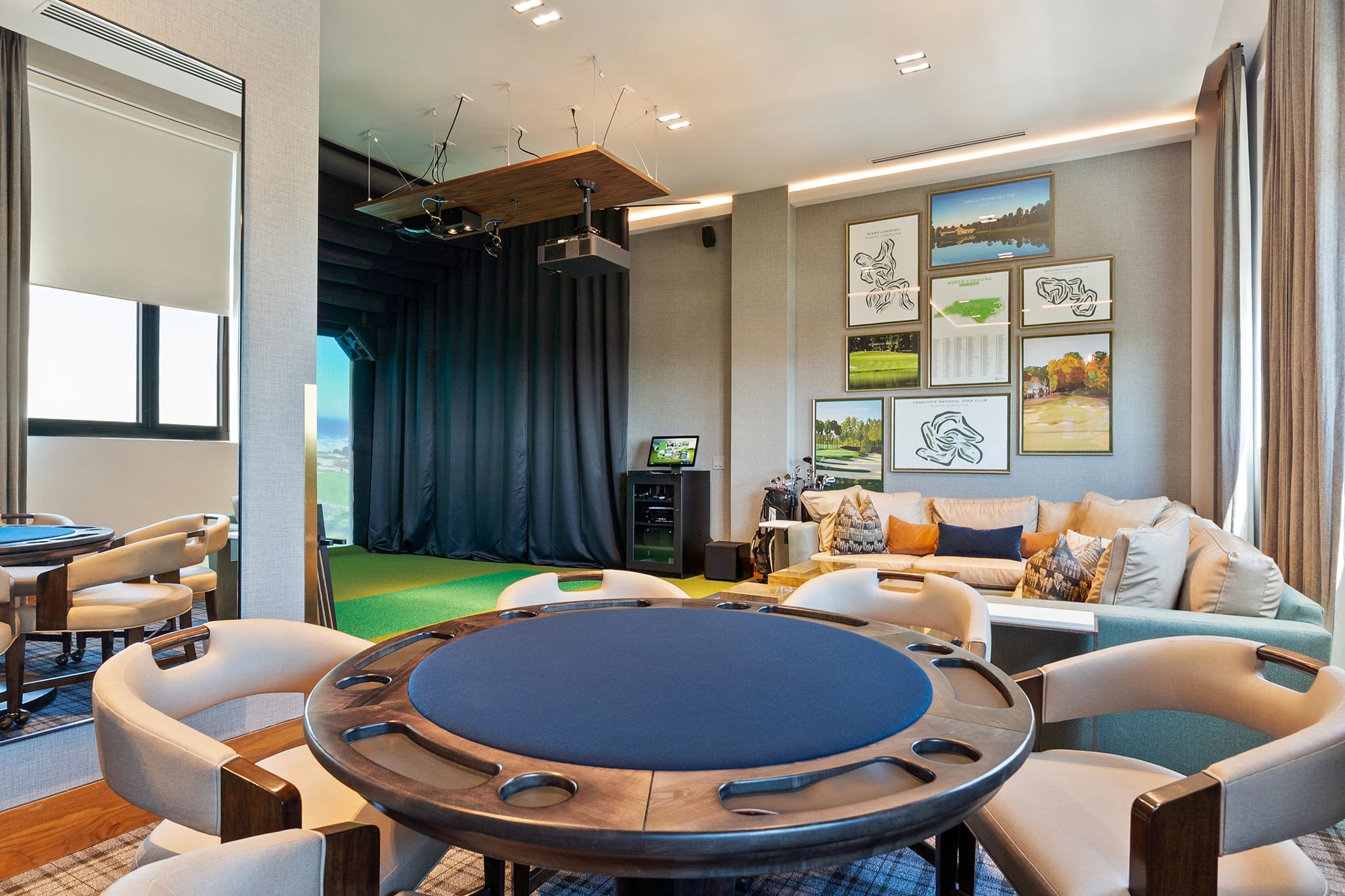 Apartment game room with poker table and modern seating