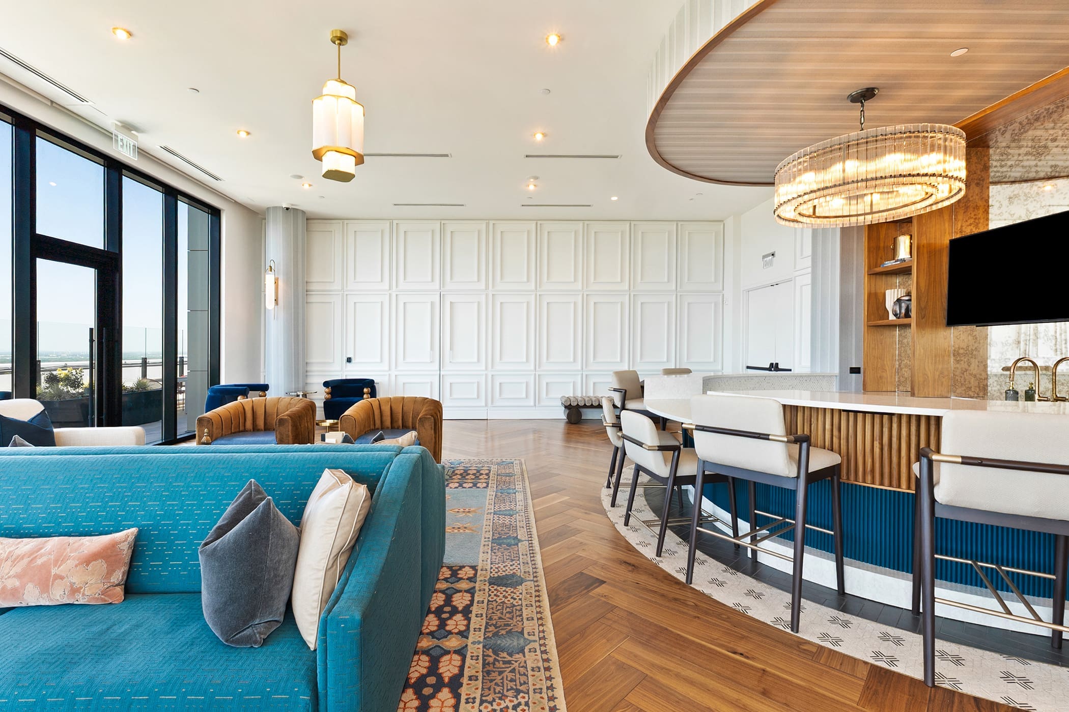Modern apartment clubhouse kitchen and lounge with city views